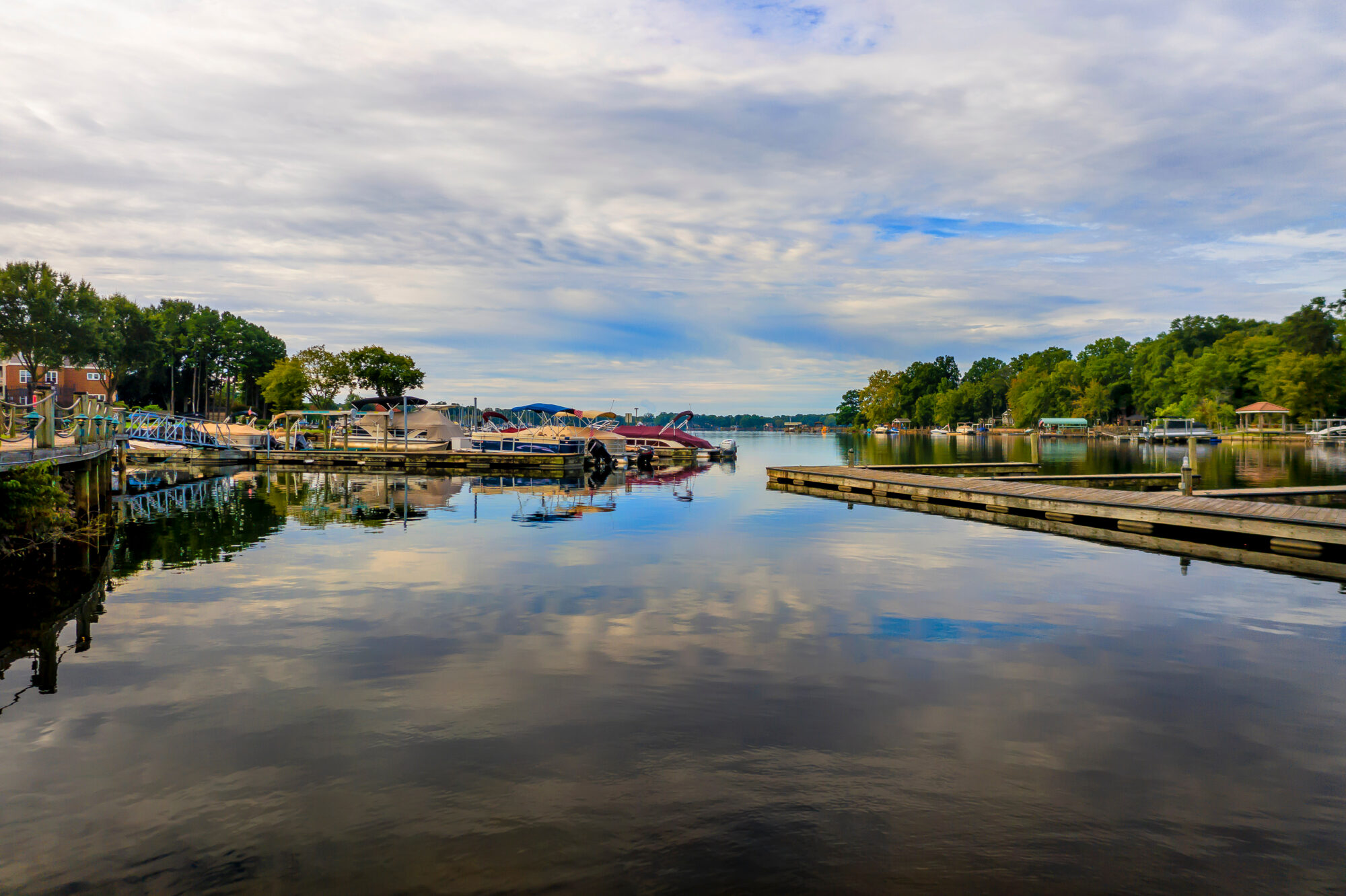 Lake with various docks and marinas, surrounded by trees